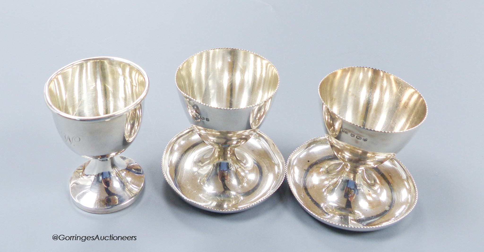 A pair of 1950's silver egg cups, Walker & Hall, Sheffield, 1957/8, 55mm and one other silver egg cup, 131 grams.
